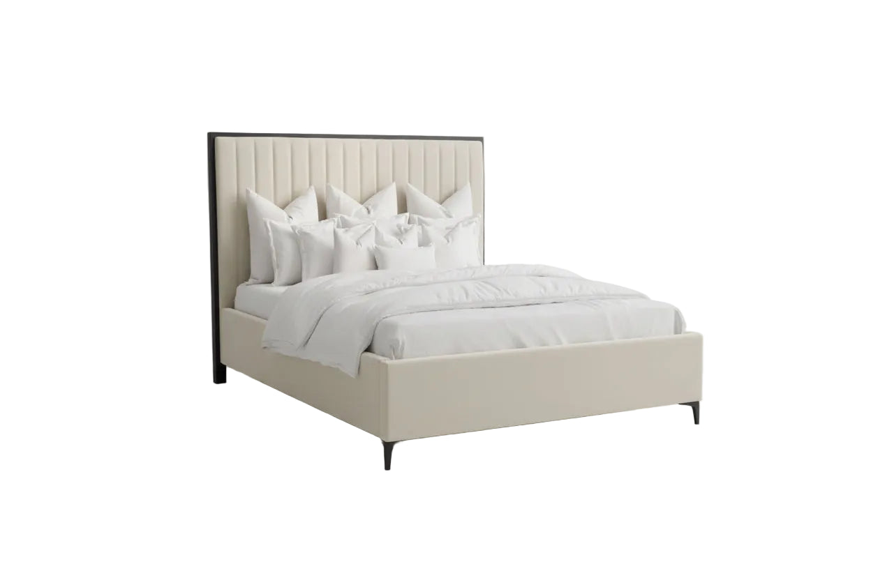 Neatly made bed with white bedding in a bedroom setting.