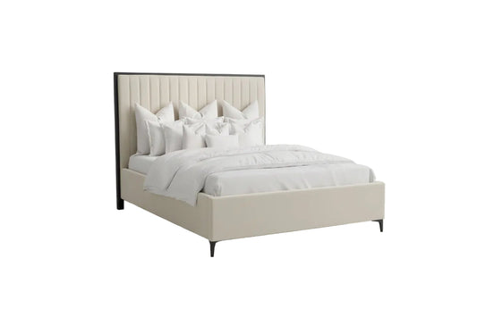 Neatly made bed with white bedding in a bedroom setting.