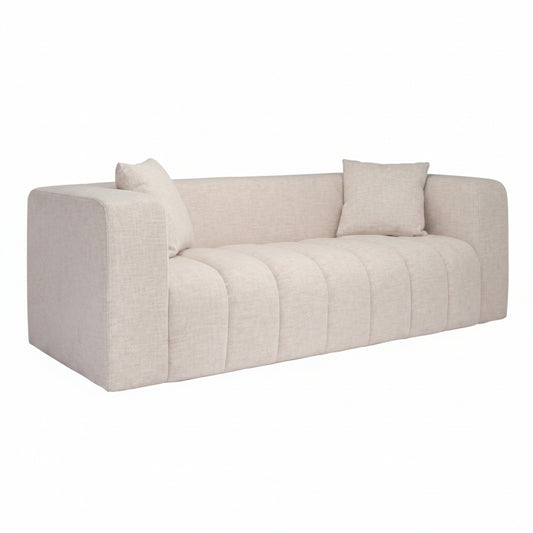 Beige sofa with two cushions on a white background